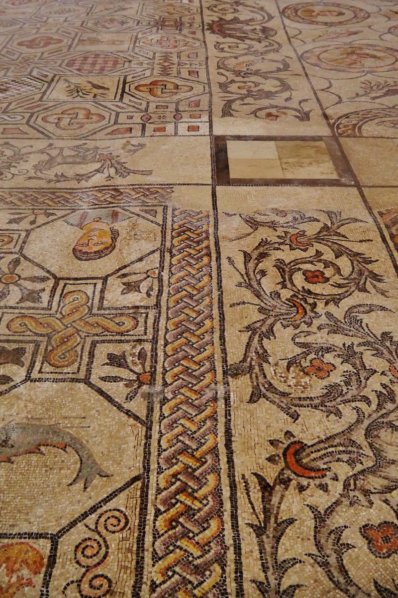 The 4th-century mosaic floor of the Basilica di Aquileia, seen from the nave with the Romanesque bell tower beyond